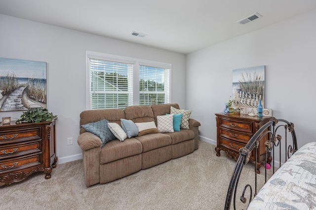 living room with light colored carpet, visible vents, and baseboards