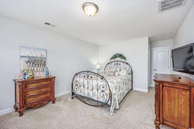 bedroom with visible vents, light carpet, and baseboards