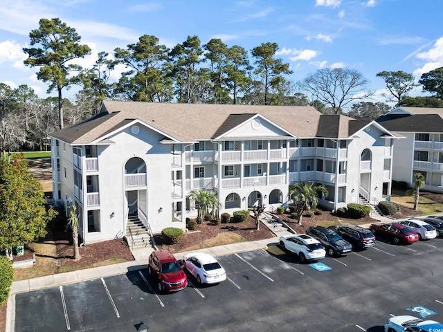 view of building exterior with uncovered parking