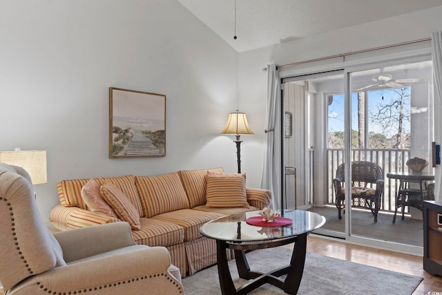 living area with lofted ceiling and ceiling fan