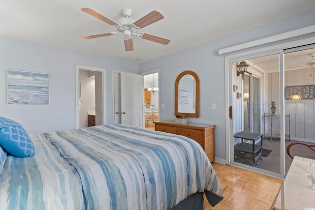 bedroom featuring ensuite bath, ceiling fan, baseboards, and a textured ceiling