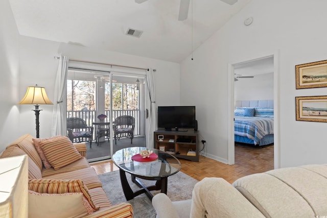 living area with lofted ceiling, ceiling fan, visible vents, and baseboards