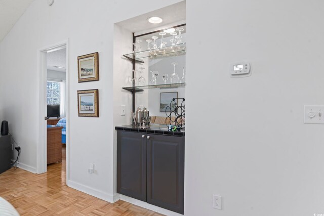 bar with wet bar and baseboards