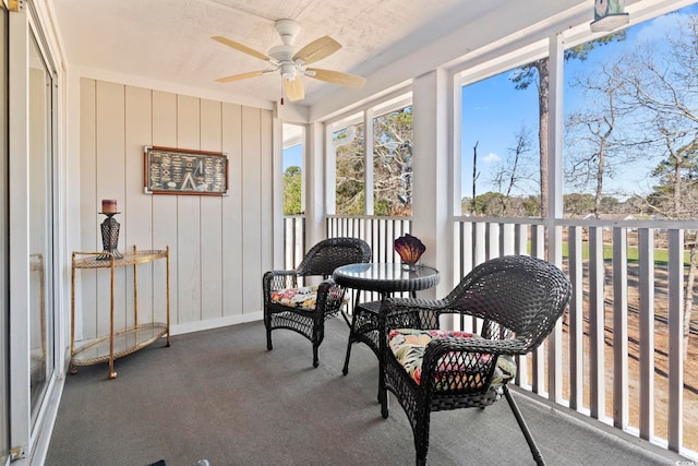 sunroom featuring a ceiling fan