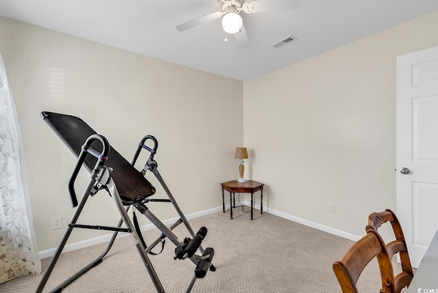 workout room with light carpet, baseboards, visible vents, and ceiling fan