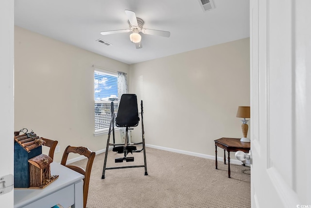 workout area featuring light carpet, baseboards, visible vents, and ceiling fan