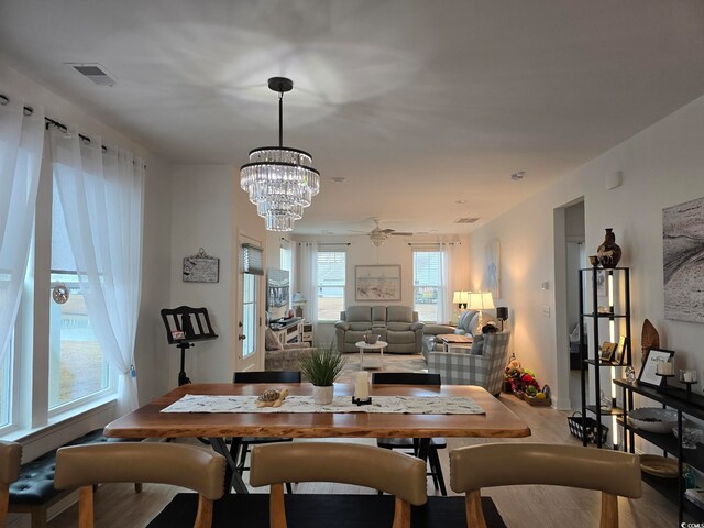 dining space featuring visible vents and wood finished floors