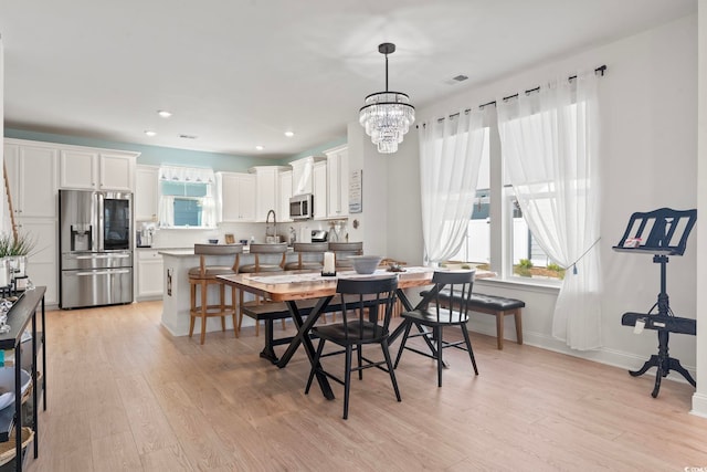 2476 Blue Crane Cir Unit 101, Myrtle Beach, SC 29577 - dining space featuring baseboards, visible vents, an inviting chandelier, and light wood-style floors