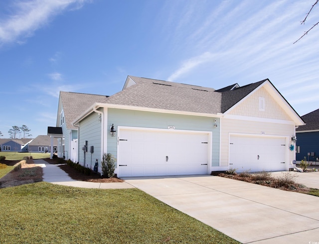 view of home's exterior with a yard, a shingled roof, an attached garage, and driveway