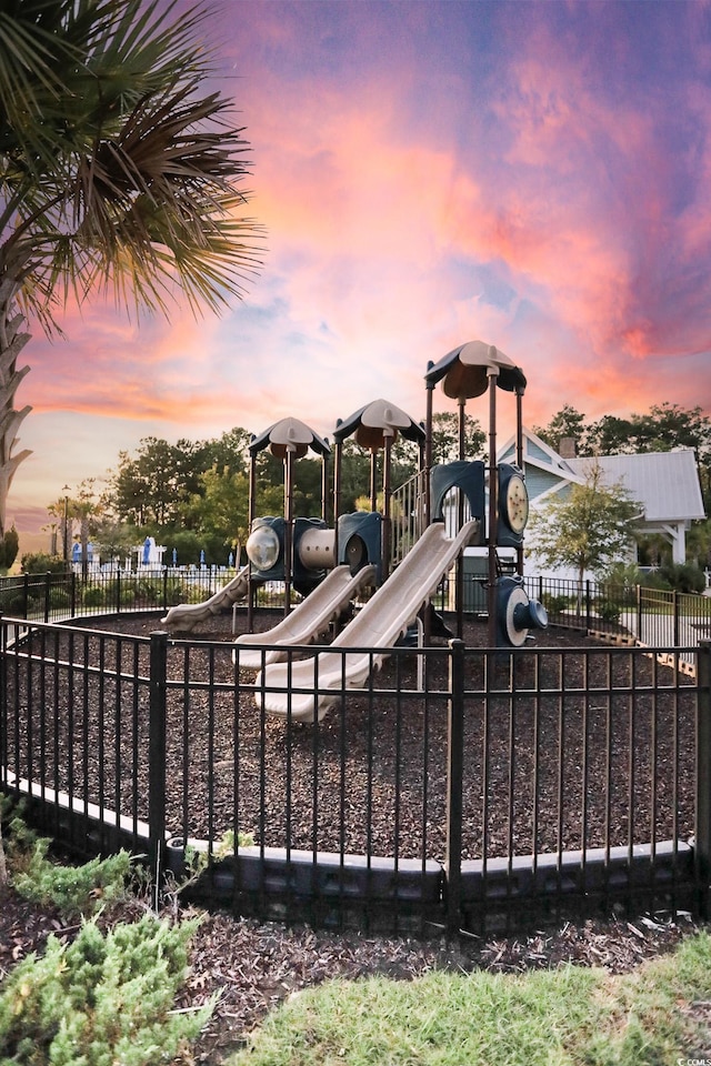 playground at dusk featuring playground community and fence