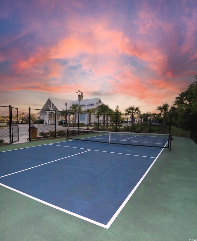 view of tennis court featuring fence