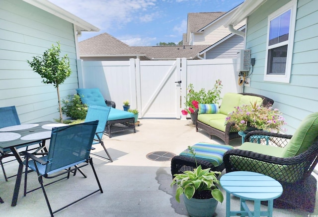 view of patio with a gate, fence, and an outdoor hangout area