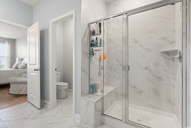 2476 Blue Crane Cir Unit 101, Myrtle Beach, SC 29577 - bathroom with a shower stall, toilet, marble finish floor, baseboards, and ensuite bath