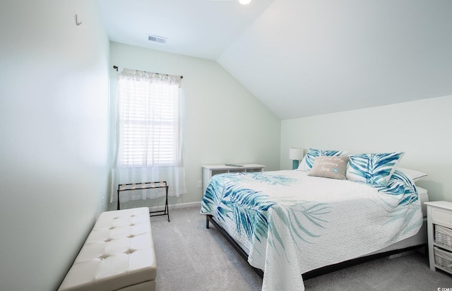 carpeted bedroom featuring visible vents and vaulted ceiling