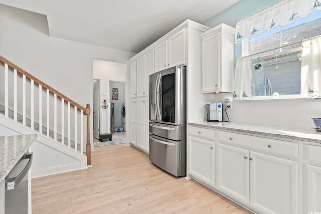 2476 Blue Crane Cir Unit 101, Myrtle Beach, SC 29577 - kitchen featuring washing machine and clothes dryer, appliances with stainless steel finishes, white cabinetry, and light wood-type flooring
