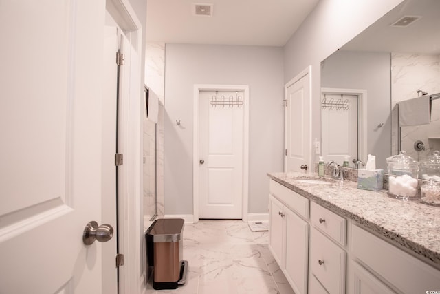 bathroom featuring marble finish floor, visible vents, a shower, and vanity