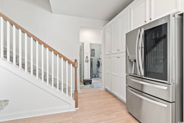 2476 Blue Crane Cir Unit 101, Myrtle Beach, SC 29577 - kitchen with white cabinets, washer and dryer, stainless steel fridge, and light wood-type flooring