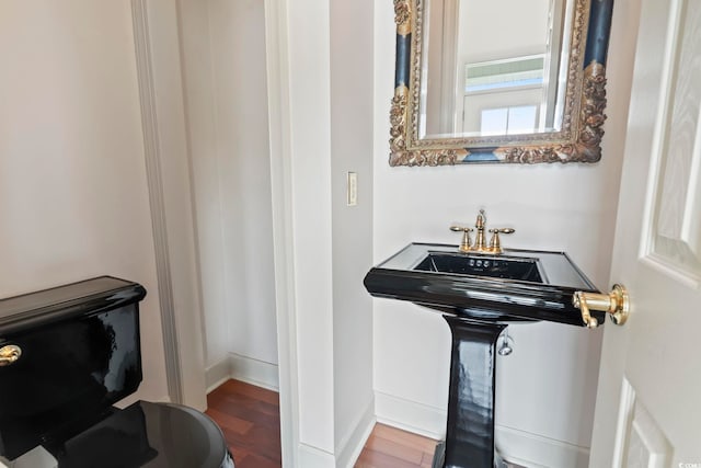 bathroom featuring baseboards and wood finished floors