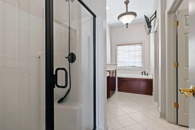 bathroom featuring a bath, tile patterned flooring, and a stall shower