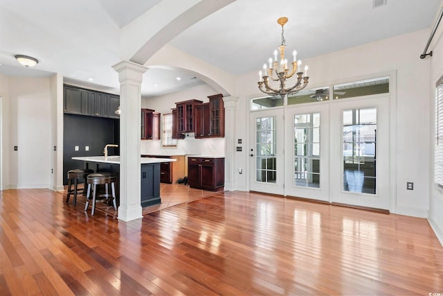 unfurnished living room featuring recessed lighting, wood finished floors, visible vents, and baseboards