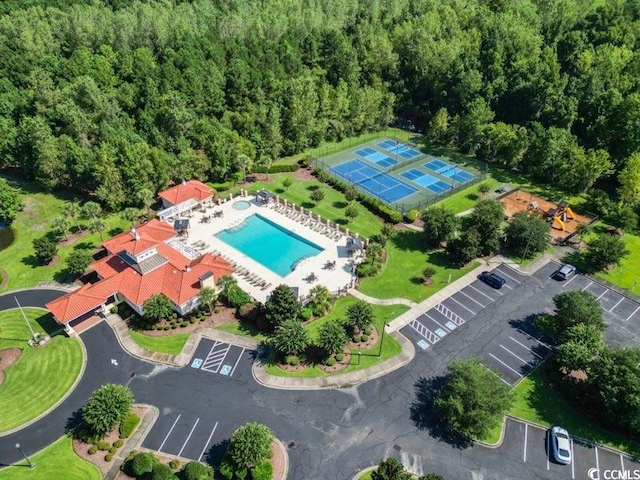 drone / aerial view featuring a forest view