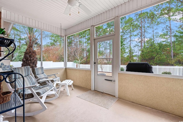 sunroom with a ceiling fan and a wealth of natural light