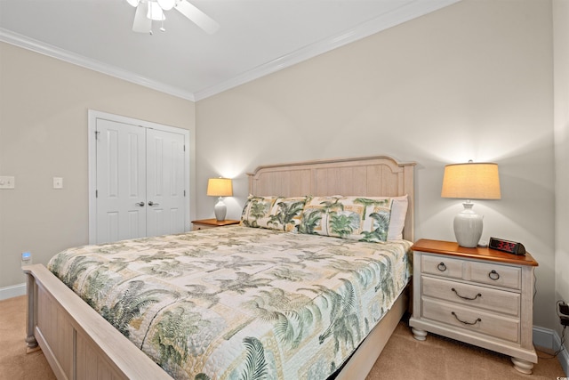 bedroom with light carpet, a closet, baseboards, and crown molding