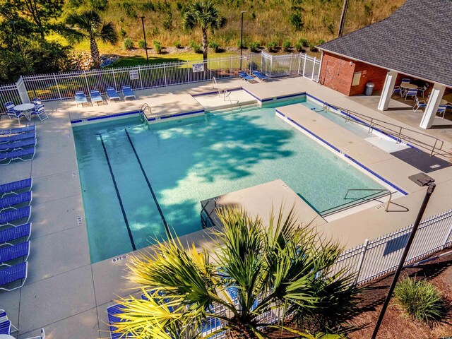 pool featuring a patio and fence