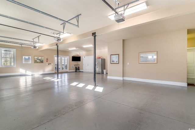 garage featuring baseboards, french doors, and a garage door opener