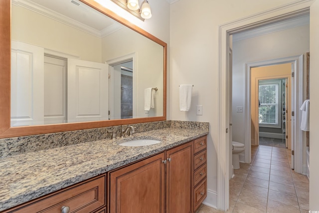 bathroom with crown molding, toilet, vanity, tile patterned flooring, and baseboards