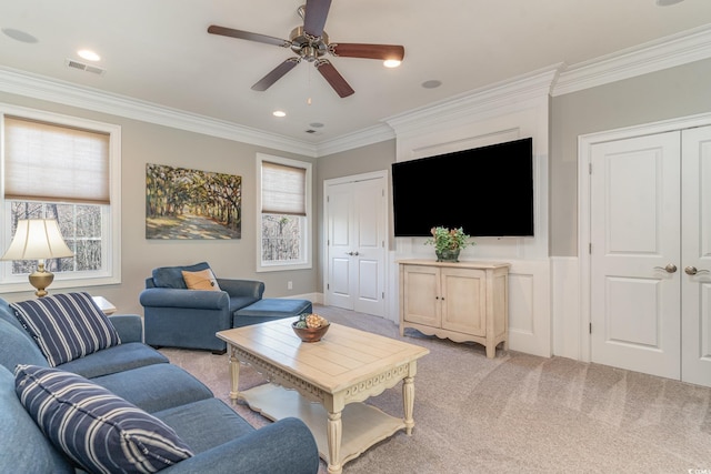 living area with recessed lighting, light colored carpet, a ceiling fan, visible vents, and crown molding