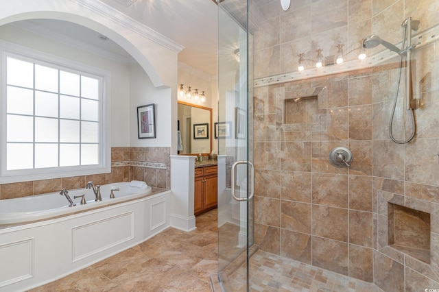 bathroom featuring a garden tub, crown molding, a shower stall, and vanity