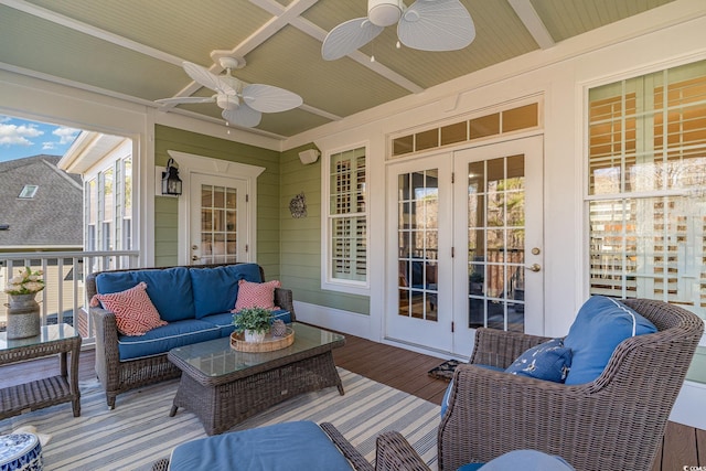 wooden terrace with a ceiling fan, french doors, and outdoor lounge area