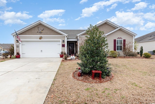 ranch-style home featuring driveway, an attached garage, and a front yard