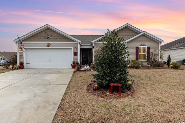 ranch-style house with driveway, an attached garage, and a lawn