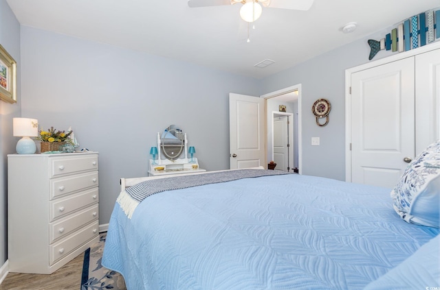 bedroom with light wood-style flooring and ceiling fan