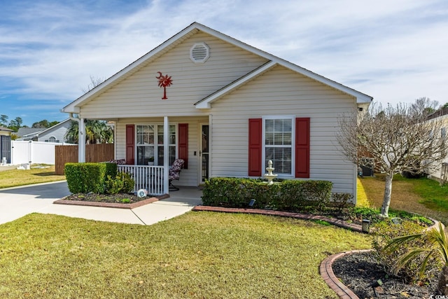 bungalow-style house with a front yard, covered porch, and fence