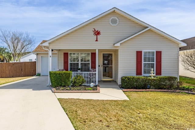 view of front of property featuring a porch, a garage, fence, driveway, and a front lawn