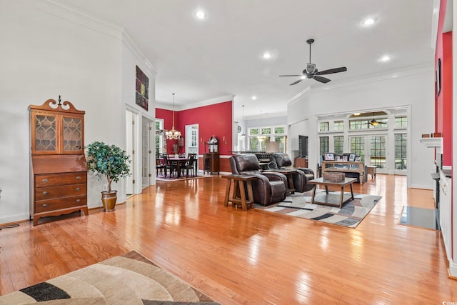 living room with light wood-style floors and crown molding