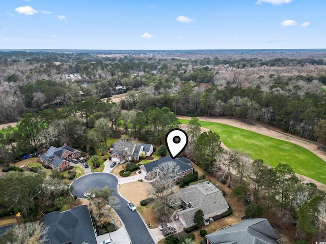 bird's eye view with a view of trees and golf course view