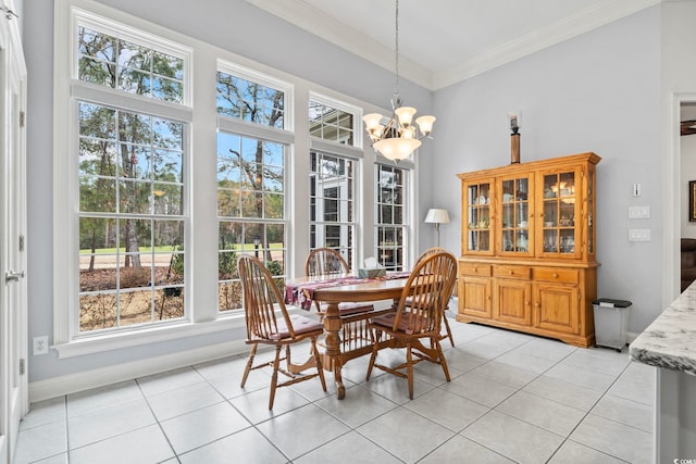 dining space featuring ornamental molding, a chandelier, baseboards, and light tile patterned floors