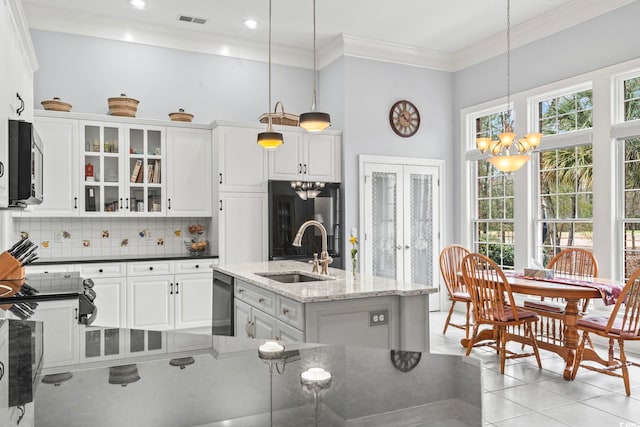 kitchen with visible vents, a sink, stainless steel appliances, french doors, and backsplash