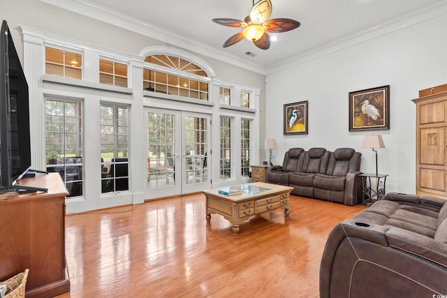 living room with ornamental molding, ceiling fan, french doors, and wood finished floors