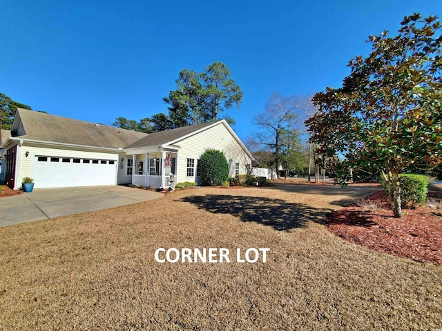 ranch-style home featuring a garage, a front yard, and concrete driveway