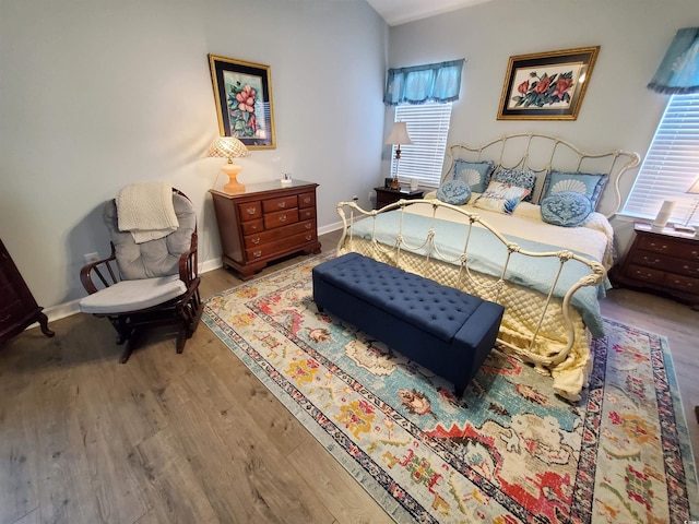 bedroom featuring baseboards and wood finished floors