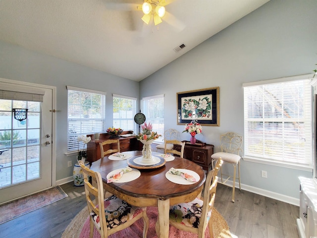 dining room with dark wood finished floors, lofted ceiling, visible vents, ceiling fan, and baseboards