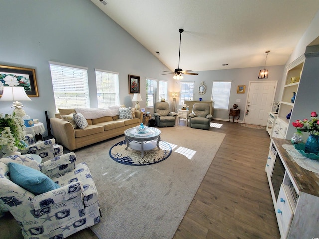 living room featuring dark wood-style floors, ceiling fan, and high vaulted ceiling