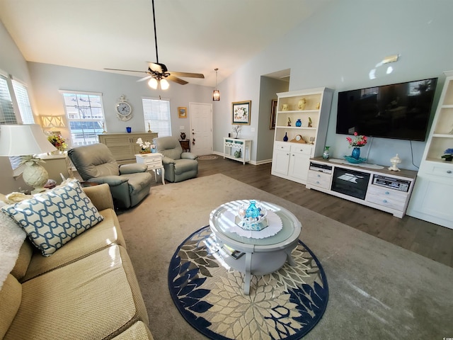 living area featuring ceiling fan, high vaulted ceiling, dark wood-type flooring, and baseboards