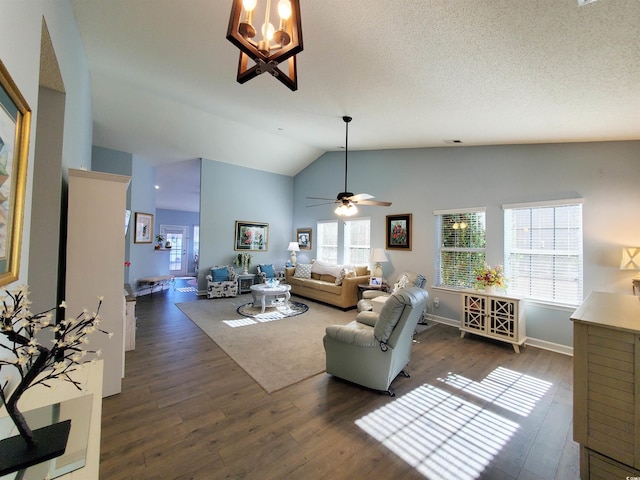 living area with baseboards, lofted ceiling, ceiling fan, dark wood-style flooring, and a textured ceiling