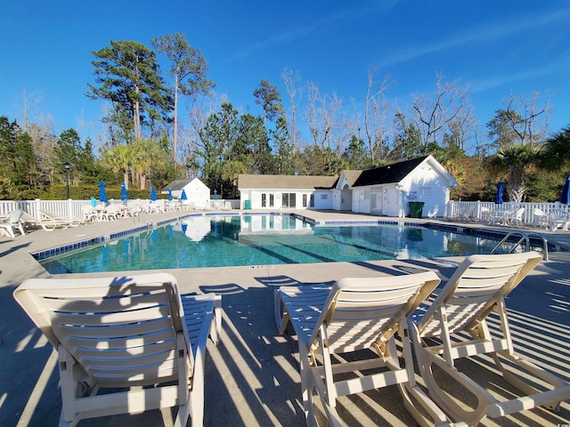 community pool featuring a patio area and fence